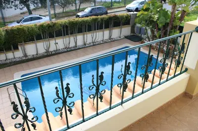 a balcony with a swimming pool in a building at Vila Montechoro in Albufeira