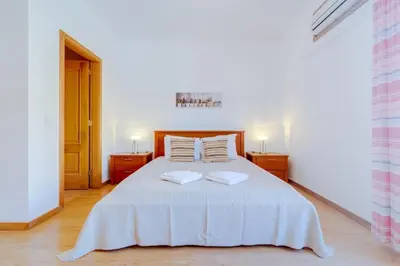 a white refrigerator in a bathroom with a shower at Collection beach side - Albufeira Oura praia 200 meters in Albufeira