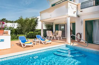a villa with a swimming pool and a house at Mng Elliott52 in Vale do Lobo