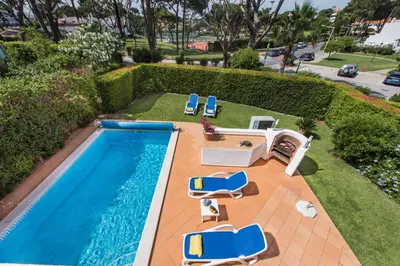 an overhead view of a swimming pool with lounge chairs and a swimming pool at Mng Elliott52 in Vale do Lobo