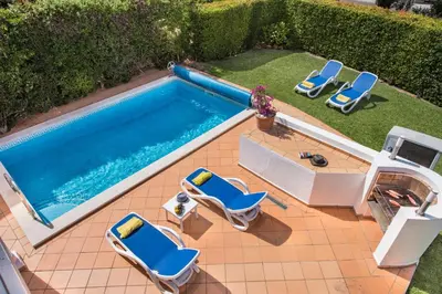 an overhead view of a swimming pool with lounge chairs and a swimming pool at Mng Elliott52 in Vale do Lobo