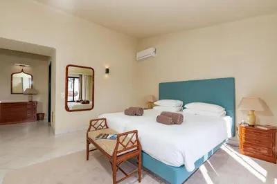 a bedroom with a large bed and a mirror at Mng Elliott24 in Vale do Lobo