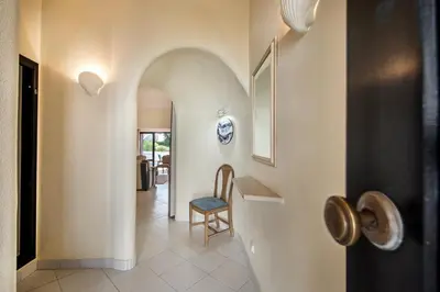 a hallway with a door with a chair next to it at Mng Elliott13 in Vale do Lobo