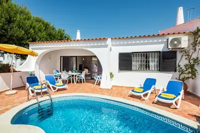 a villa with a swimming pool and a patio at Mng Elliott13 in Vale do Lobo