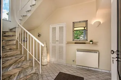a staircase in a home with a window and a mirror at Mng Elliott76 in Vale do Lobo