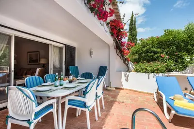 a patio with a table and chairs on a balcony at Mng Elliott76 in Vale do Lobo