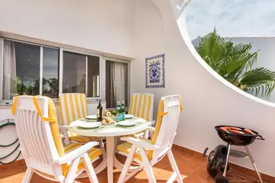 a dining room with a white table and chairs at Mng Elliott91c in Vale do Lobo