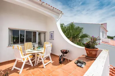 a patio with a table and chairs on a balcony at Mng Elliott91c in Vale do Lobo