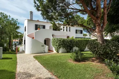 a white house with a tree in the yard at Mng Elliott91c in Vale do Lobo