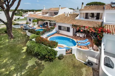 an aerial view of a house with a swimming pool at Mng Elliott71 in Vale do Lobo