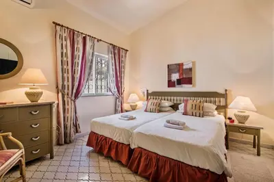 a bedroom with a bed and a window at Mng Elliott53 in Vale do Lobo
