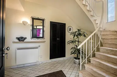 a hallway with stairs and a black door at Mng Elliott53 in Vale do Lobo