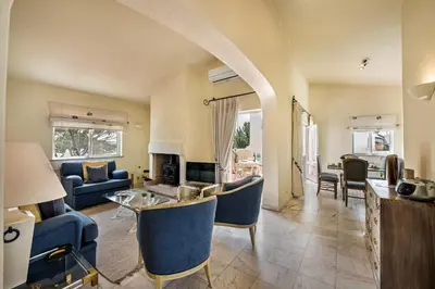 a living room with blue couches and a fireplace at Mng Elliott90c in Vale do Lobo