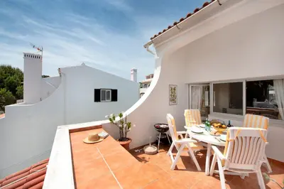 a patio with a table and chairs on a balcony at Mng Elliott90c in Vale do Lobo