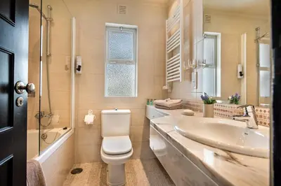 a bathroom with a toilet and a sink at Mng Elliott90c in Vale do Lobo