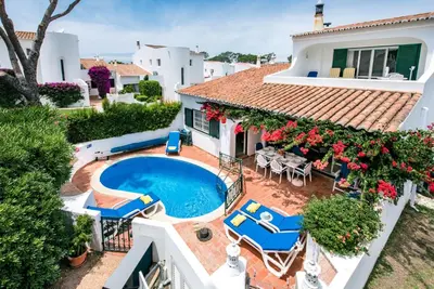 a villa with a swimming pool and patio furniture at Mng Elliott49 in Almancil