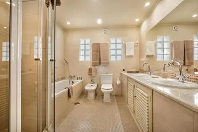 a bathroom with a toilet and a sink and a shower at Mng Elliott37 in Vale do Lobo