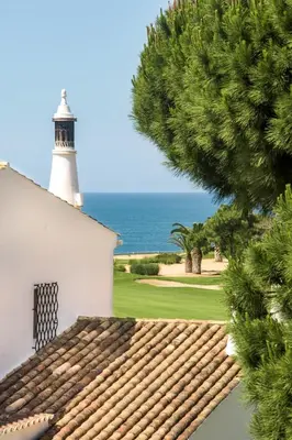 a lighthouse sitting on top of a white building at Mng Elliott37 in Vale do Lobo