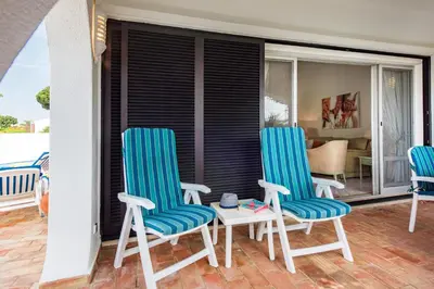 two blue chairs and a table on a balcony at Mng Elliott31 in Almancil