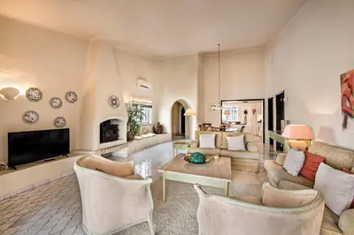 a living room with a couch and a table at Mng Elliott31 in Almancil