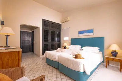 a bedroom with a large bed with a blue headboard at Mng Elliott46 in Vale do Lobo