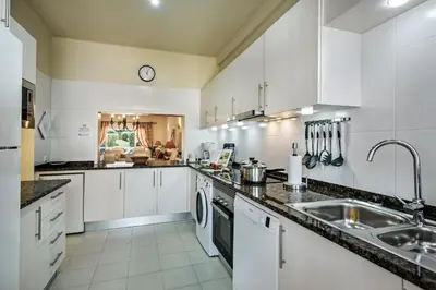 a kitchen with white cabinets and a sink at Mng Elliott46 in Vale do Lobo