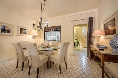 a dining room with a table and white chairs at Mng Elliott46 in Vale do Lobo