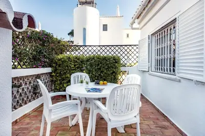 a patio with a table and chairs and an umbrella at Mng Elliott42 in Vale do Lobo