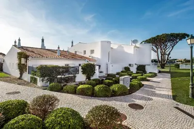 a house with a gate to a patio with a table at Mng Elliott42 in Vale do Lobo