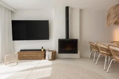 a living room with a fireplace and a flat screen tv at Modern retreat 3 Bedroom in Vilamoura in Quarteira