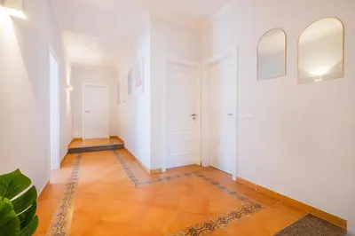 a hallway with white walls and orange tile floors at Vicente Mar Luxury Villa - Private Pool in Albufeira