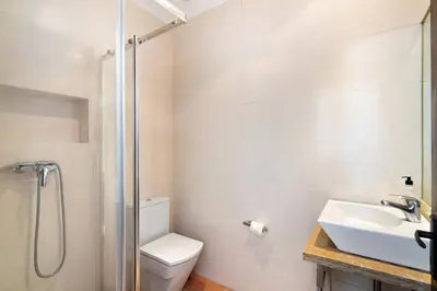 a bathroom with a toilet and a sink and a shower at Villa Aveiros in Albufeira
