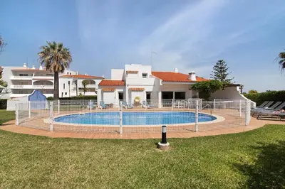 a house with a swimming pool in front of a house at Villa Aveiros in Albufeira