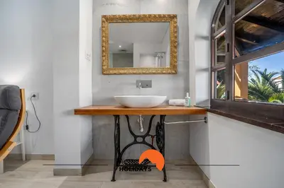 a bathroom with a sink and a mirror at #213 Vila Roja Pé by Home Holidays in Albufeira
