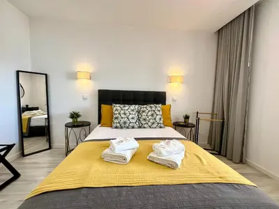 a bedroom with a large bed with towels on it at Albufeira Twins 3 With Pool by Homing in Albufeira