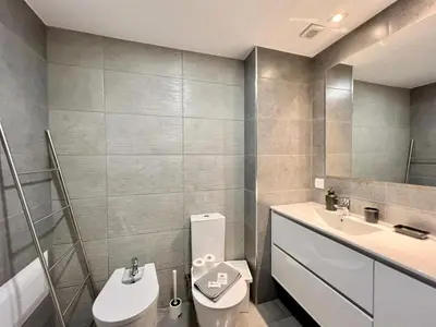 a bathroom with a toilet and a sink at Albufeira Twins 3 With Pool by Homing in Albufeira