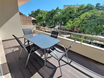 a table and chairs on a balcony with a view at Al Baltum in Albufeira