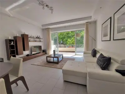 a living room with a white couch and a table at Al Baltum in Albufeira