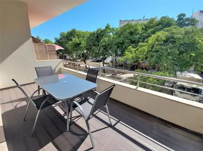 a table and chairs on a balcony with a view at Al Baltum in Albufeira