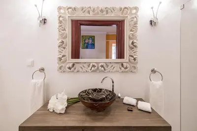 a bathroom with a sink and a mirror at TheBougainVilla our Oceanview Villa in the Hills in Boliqueime