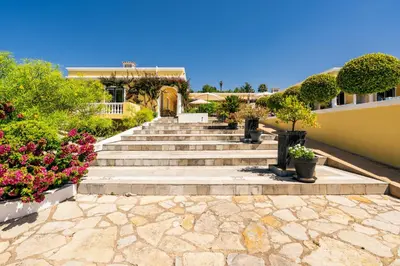 a set of stairs leading to a building with flowers at TheBougainVilla our Oceanview Villa in the Hills in Boliqueime