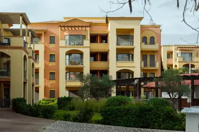 an apartment building with balconies and trees at The Residences Vilamoura in Vilamoura