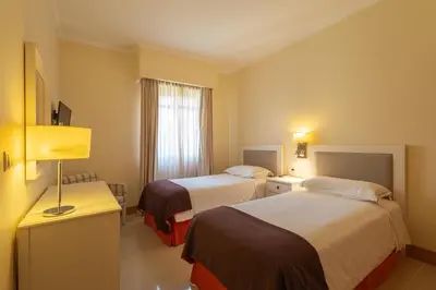 a hotel room with two beds and a window at The Residences Vilamoura in Vilamoura