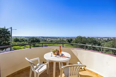 a table and chairs on a balcony with a view at Villa Casa Coelho by Villa Plus in Terras Novas