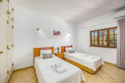a room with two beds and a window at Villa Casa Coelho by Villa Plus in Terras Novas