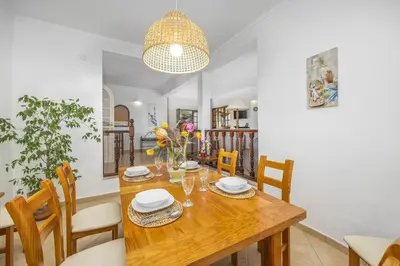 a dining room with a wooden table and chairs at Villa Casa Coelho by Villa Plus in Terras Novas