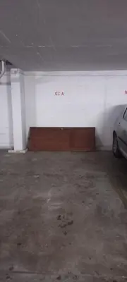 a parking garage with a sign that says go at Beachfront flat with pool in Quarteira