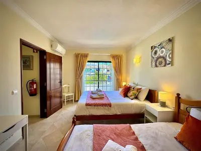 a bedroom with two beds and a window at Albufeira Summer Villa 1 With Pool by Homing in Albufeira