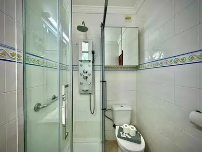 a bathroom with a shower and a toilet and a sink at Albufeira Summer Villa 1 With Pool by Homing in Albufeira