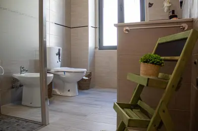 a bathroom with a toilet and a sink at Casa Amarela - Conforto e localização central! in Faro